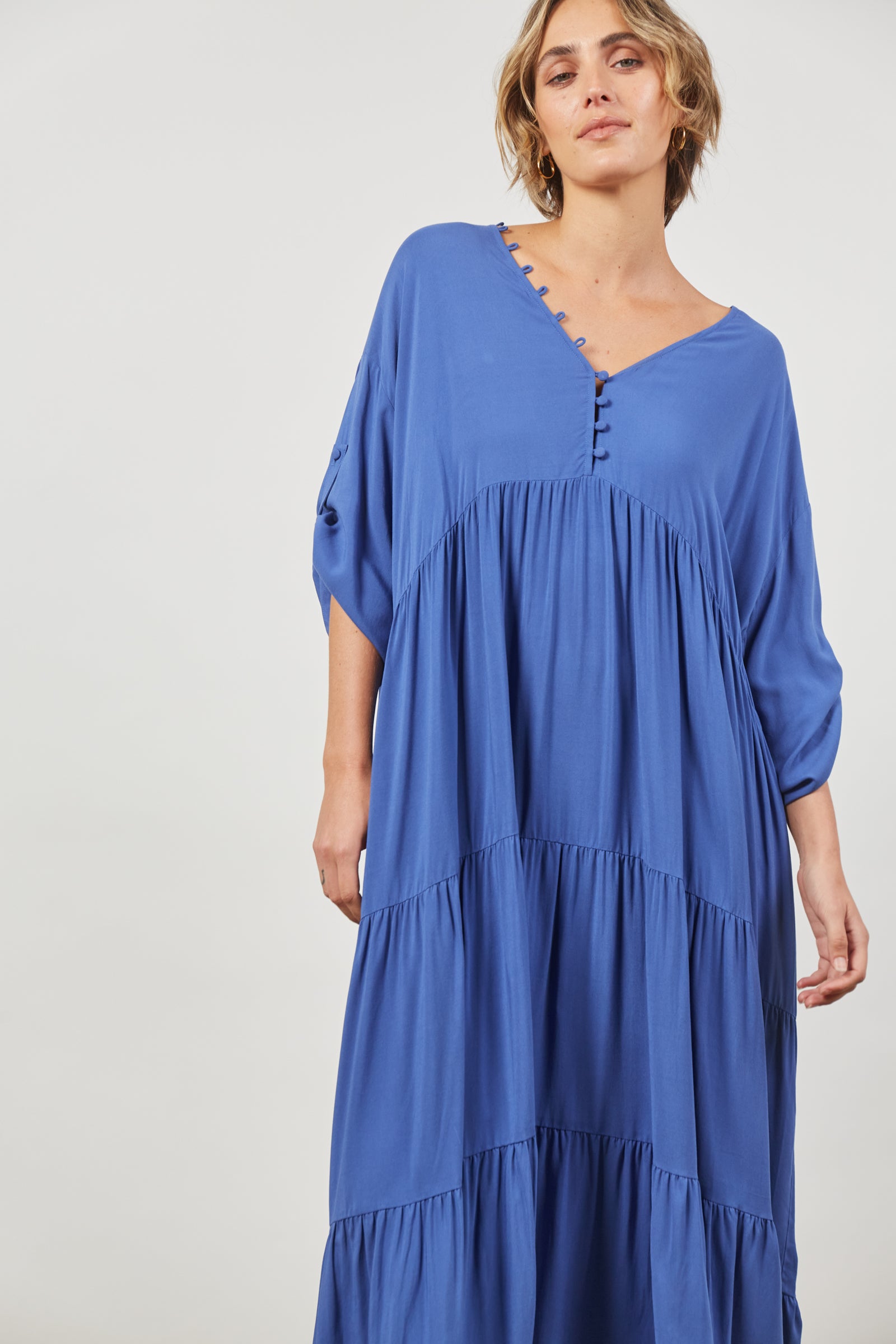 ladies azure blue maxi dress  v neck with button loop detail gathering under bust. long sleeves with tab