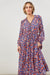 front view of women's maxi romance tiered dress  v-neck with detailing, gorgeous floral print all over, long sleeves 