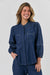 GA566 by Naturals by O&J, a dark denim blue shirt with long sleeves, contrast stitching in white and elasticated sleeves.