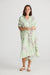 Modle in Cayman Overshirt Midi Dress in Waterlily by Holiday.