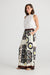 Side of Playa Trousers in geometric island print of yellow white brown and black.