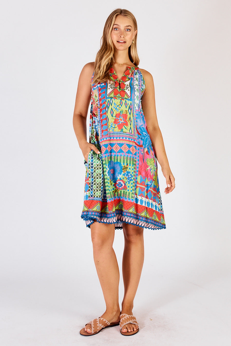 Sleeveless floral and geometric midi dress with a v-neck and pockets in melon a green, blue and red multi colours.