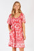 LulaLife Agatha Shirred Midi Dress in Melon Red and White tropical print.