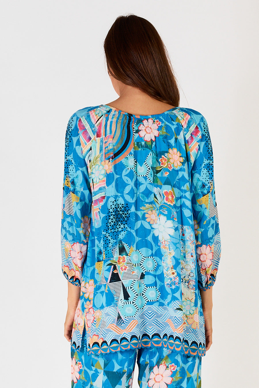 Back of ladies Amalfi tunic style top with contrasting hem print in blue, orange, white print by LulaSoul.