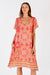 Pink and orange star print midi dress with v-neck, short sleeves and relaxed fit by LulaSoul.