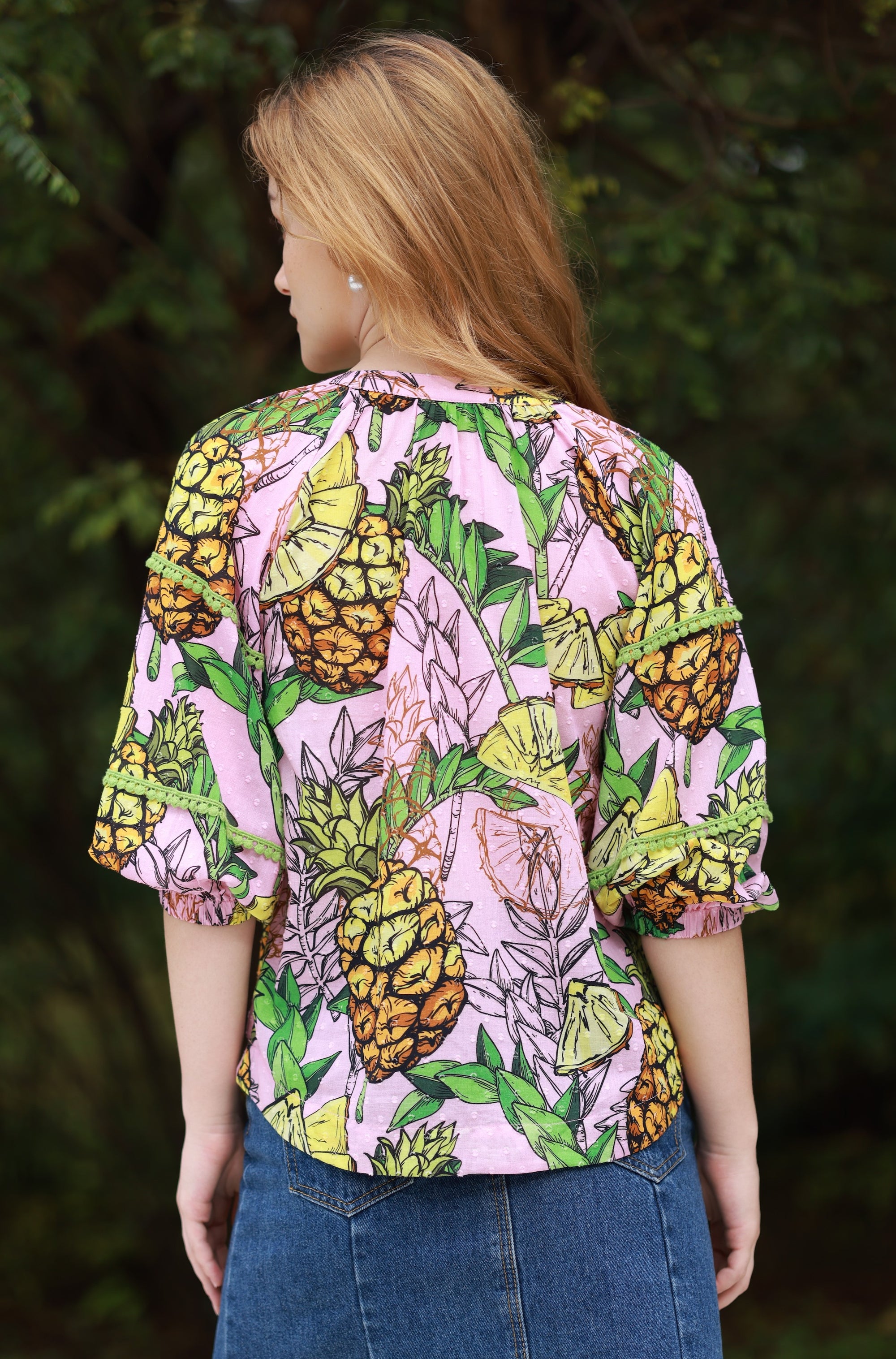 Back of Trixie Top from Maude Vivante in pineapple print (pink, yellow and green).