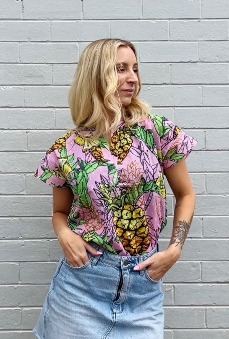 Model wearing Maude Vivante ladies Joy Top in Pineapple print. 