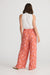 Back of Women's full length elasticated waist pants in pink and red by Holiday.