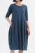 Close up of Blue Diagonal Dress showing Round Neck, 3/4 sleeves, balloon skirt, and pockets. 