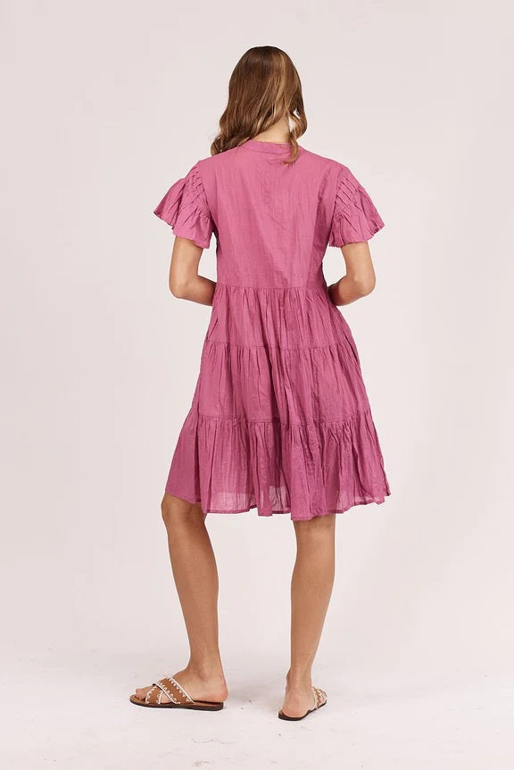 Back of Pink Fuchsia cotton midi dress with gathering across chest, vneck and tiered skirt. 