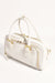 Adorne's Ottilie Bowler Hand Bag in white with gold accents and zip compartments. 