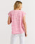 Model showing back of women's striped t-shirt in pink and red by Betty Basics.