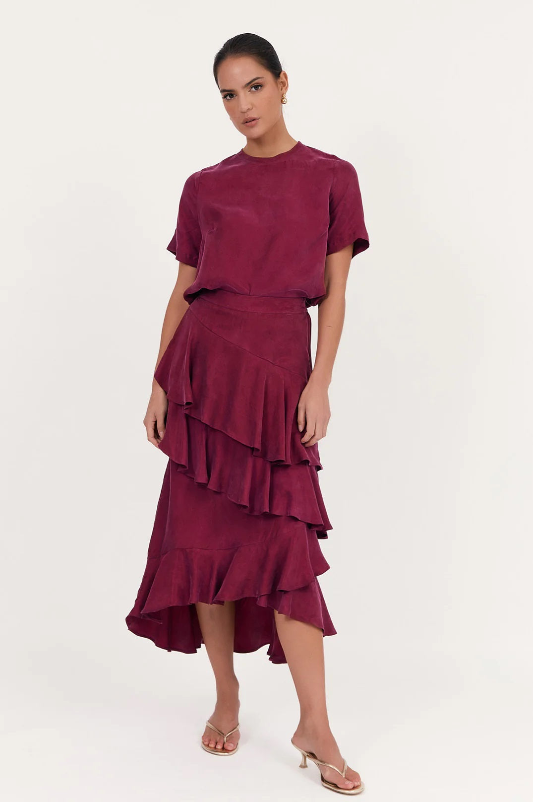 Adorne midi Peta Ruffle Cupro skirt in burgundy with layers of frills and a high low hem. 