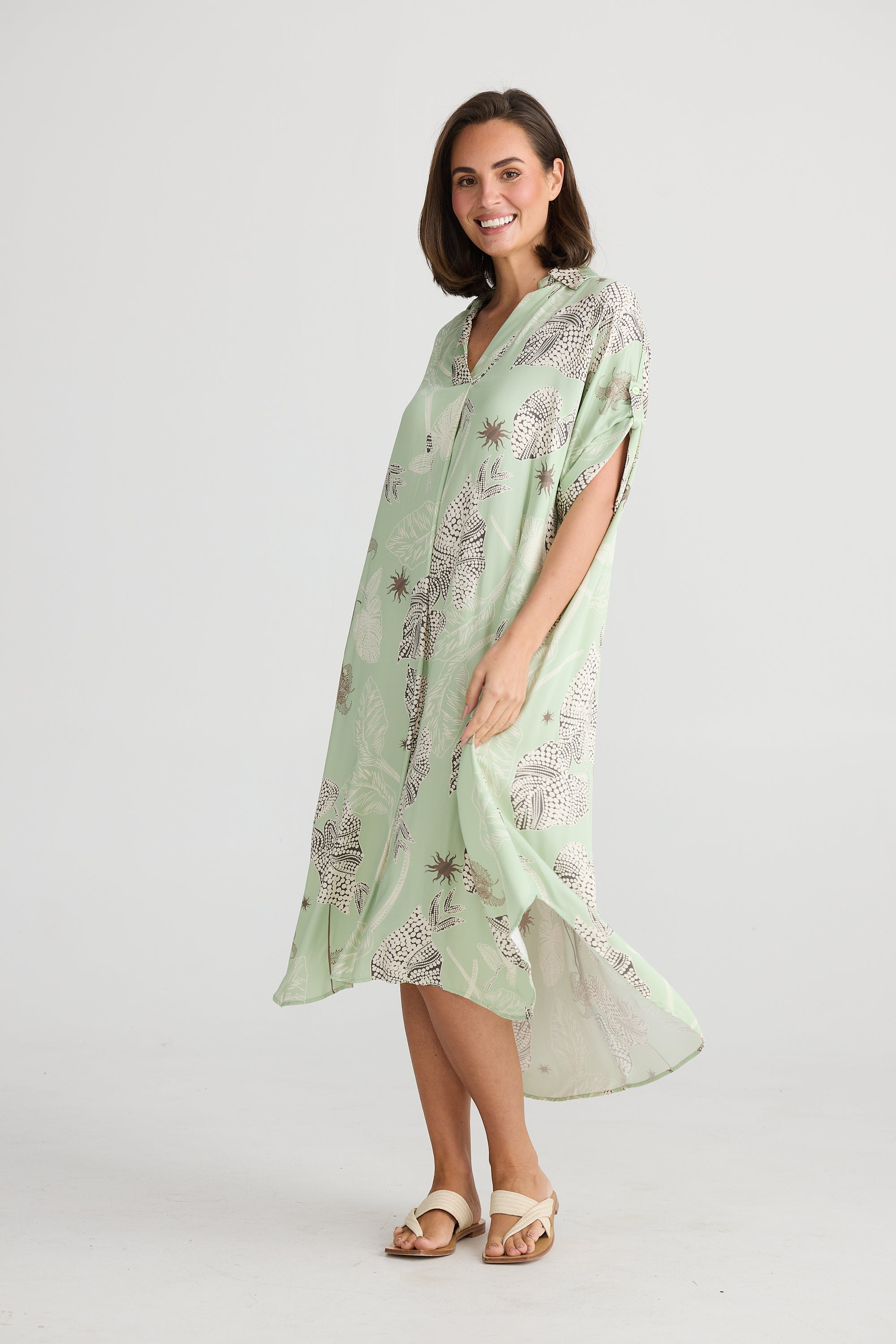 Side view of oversized lily leaf print cayman midi dress by holiday.