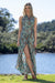 Model wearing Cienna's Syrena floral halter style maxi wrap dress in Green red and Gold.