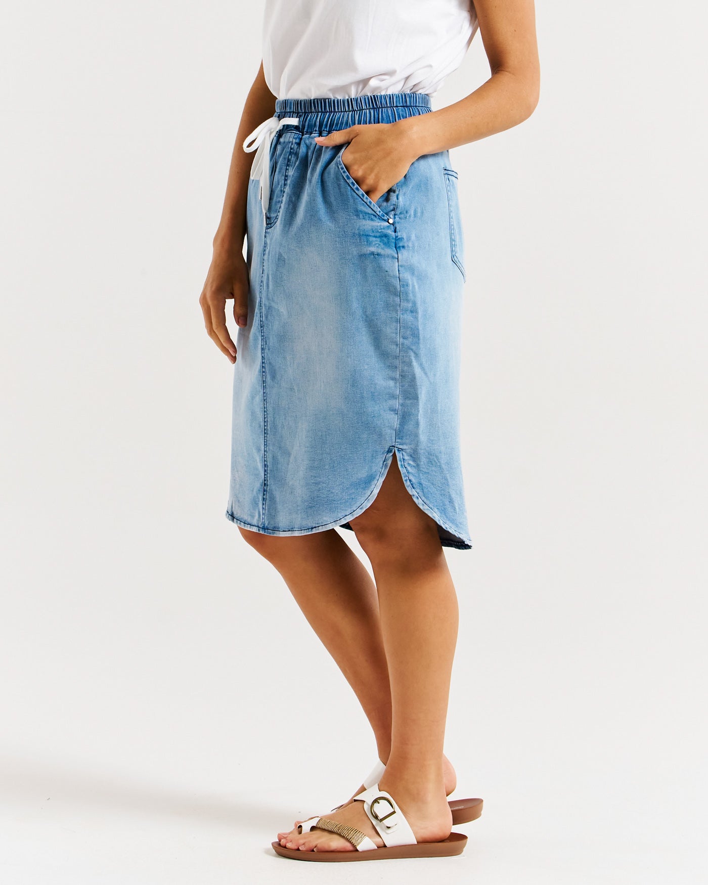 side view of Alina Faded Blue denim skirt with pockets and side splits by Betty Basics.