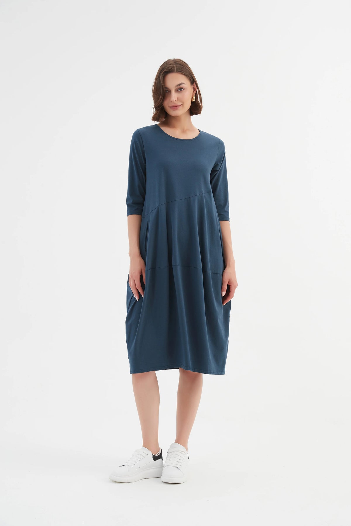 Model wearing Tirelli&#39;s Summer version of the Diagonal Seam Dress in Deep Teal.