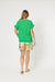 Tulum vneck Top in green side view short sleeves with frill on cuffs and hems.