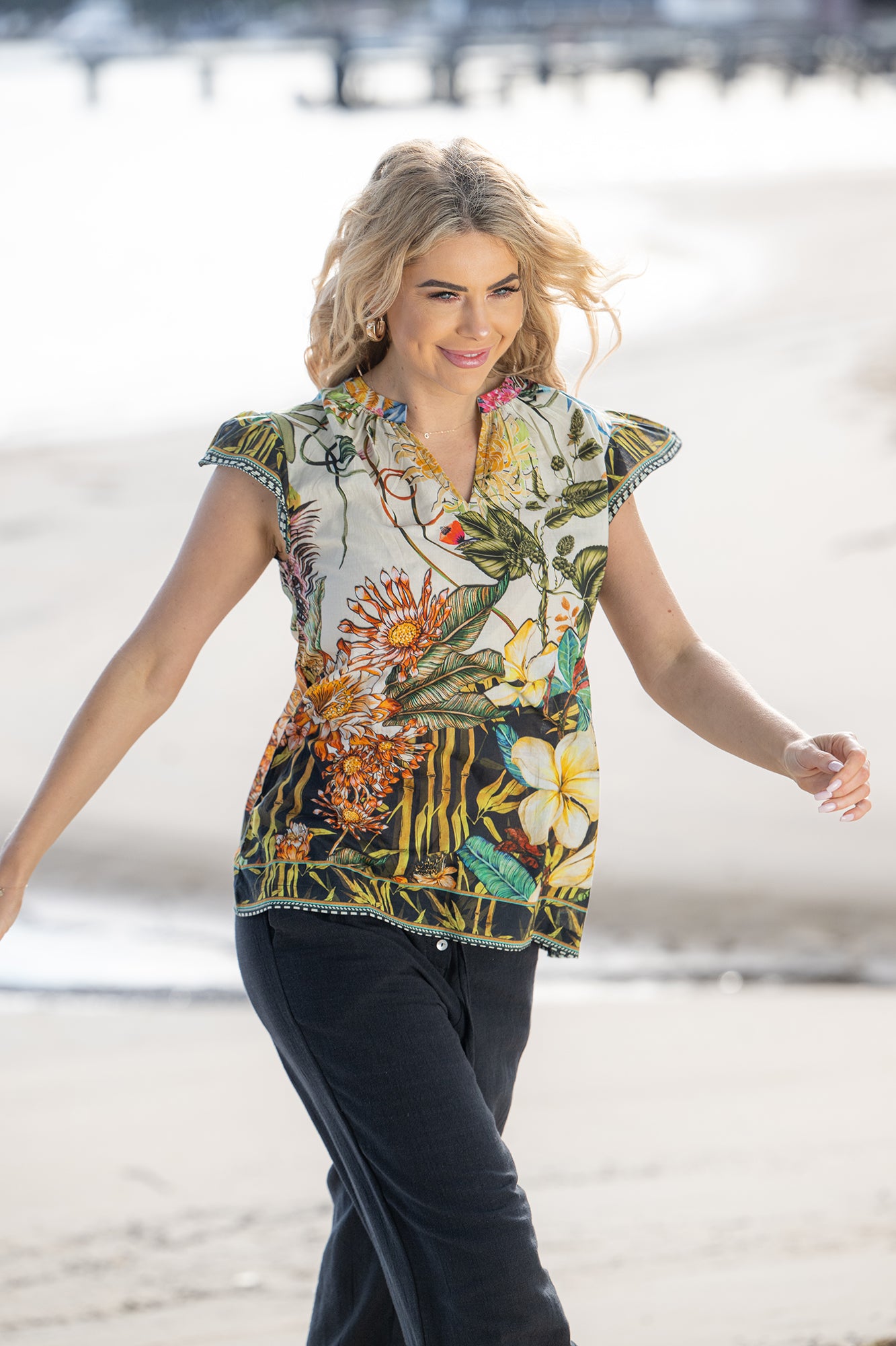 Destiny Floral Cotton Sarah Top by Cienna is a white shirt with green, yellow, orange print.