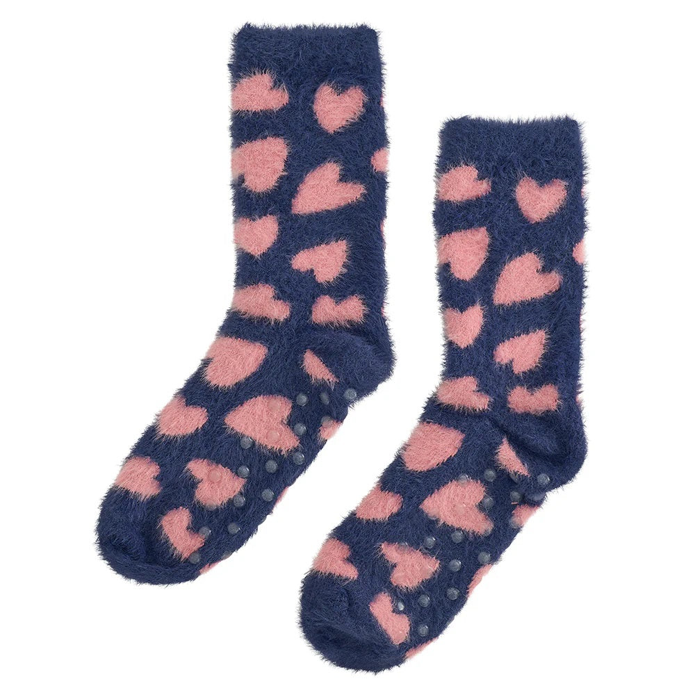 Navy blue fuzzy bed socks with pink hearts on them and grips on the bottom by Annabel Trends.