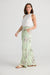 Side view of waterlily print cotton playa trousers with elasticated waist in pale green by Holiday.