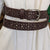 Brown Floral Embossed Belt on Dress showing belt loops and decorative perforation.