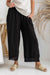 Ladies pineta black linen pants with open weave hem by The Italian Cartel.