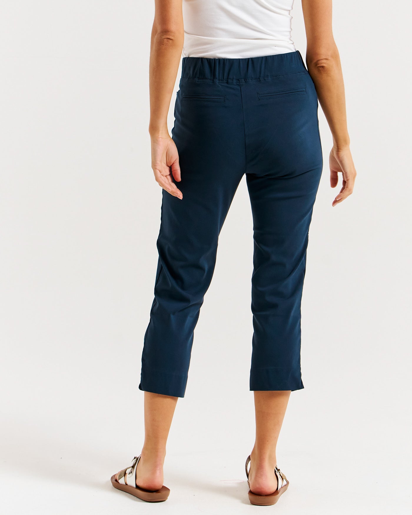 model showing the back of the crop bengaline pants in navy by betty basics.