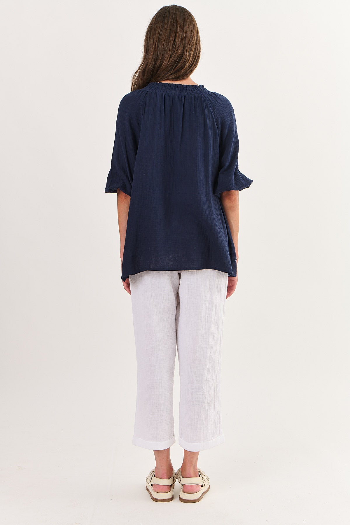 Back of Namastai crinkle cotton mooring (navy blue) top with gathered neck and tassels.