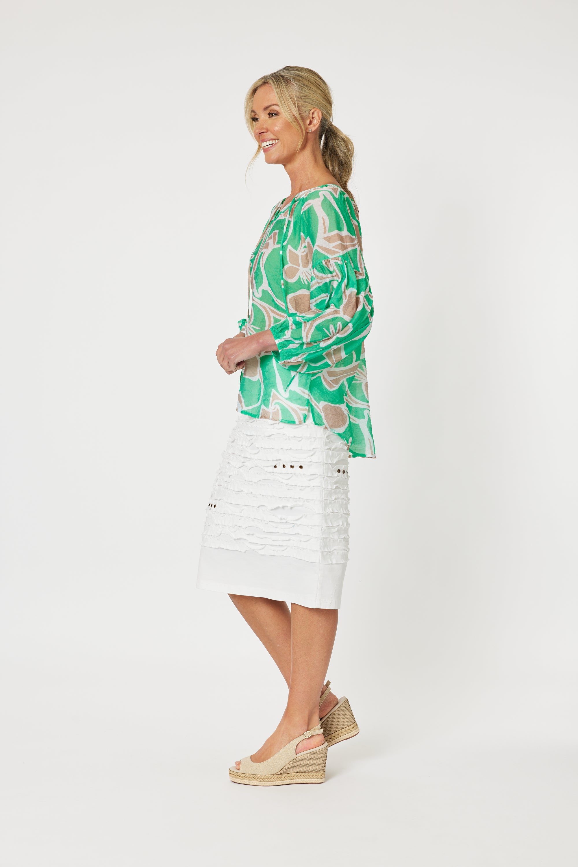 Noosa Beach Top has a high low hem, v-neck with tassels and is mint green, white and natural leafy print.