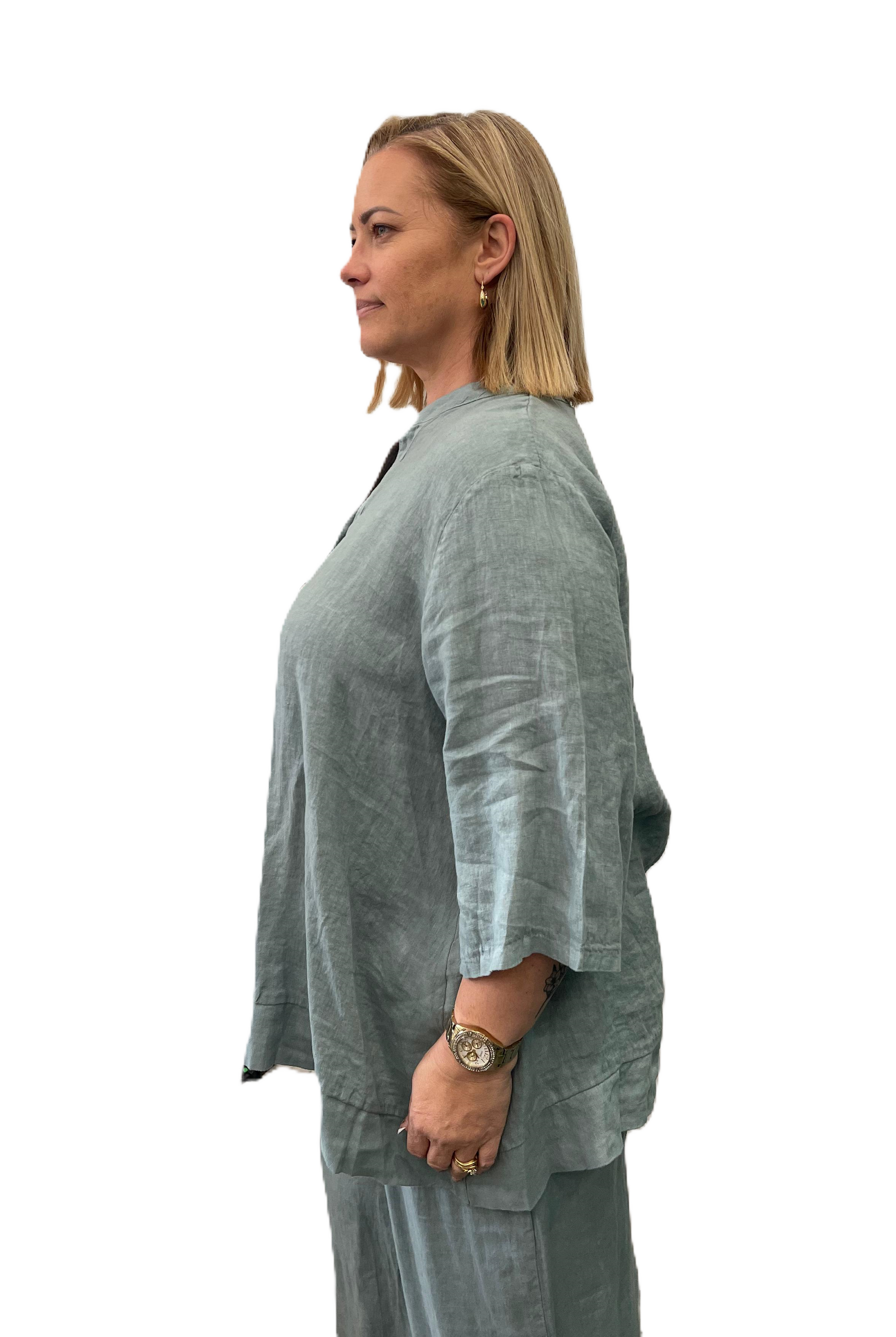 Side View of Aversa Linen blouse in blue wtih 3/4 sleeves and a relaxed fit.