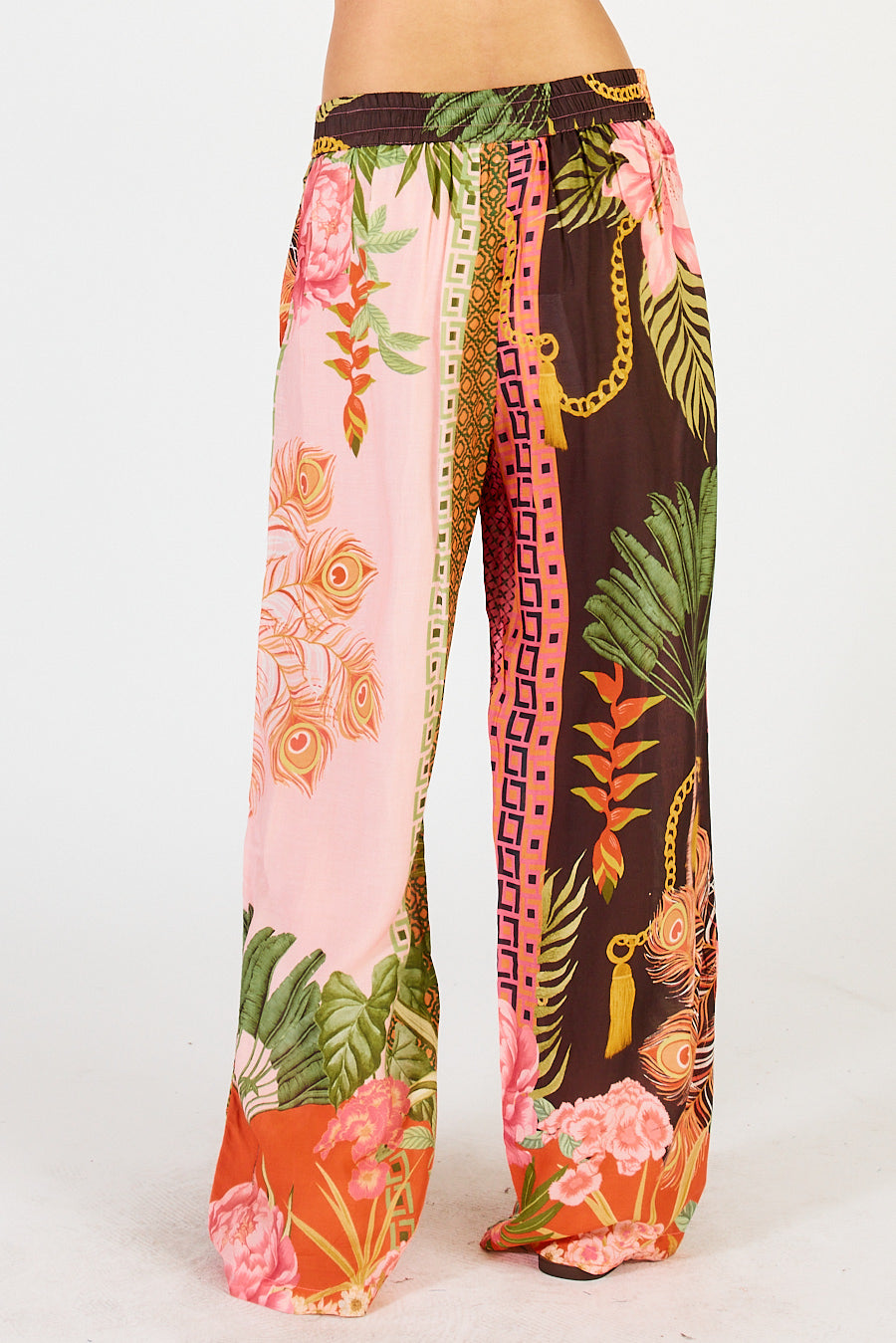 Back of the Ravello Pants by Lulasoul, in a multicoloured print, one leg pink , one dark brown with a fun feather floral print.