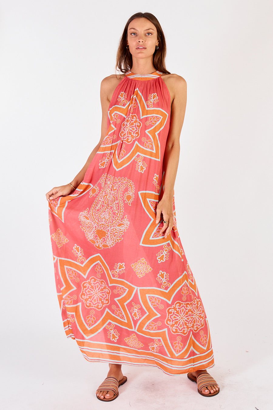 Monaco Maxi Dress held out by model to show star print, without the belt.