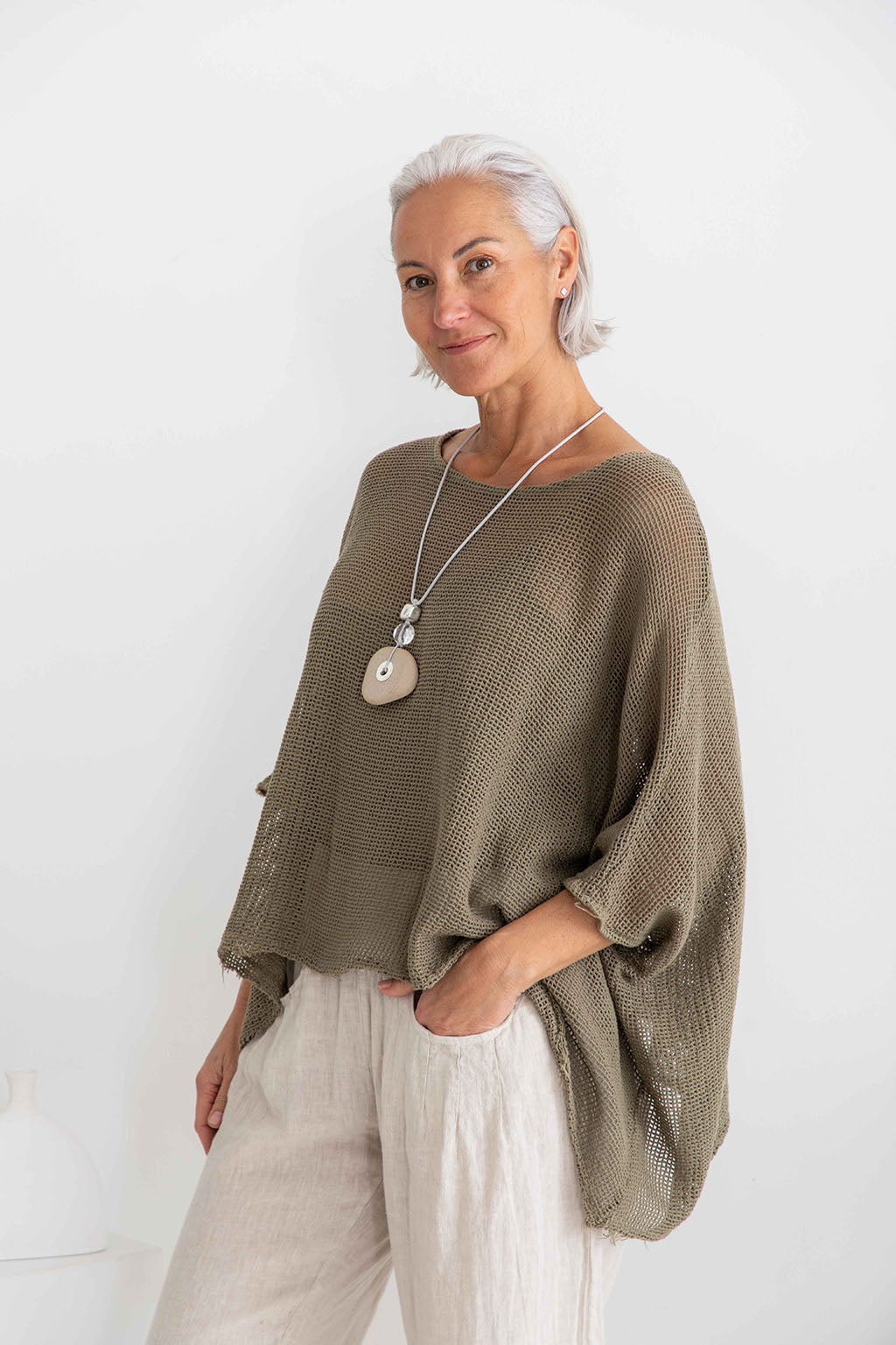 Ladies slate / khaki layered top open weave top with batwing sleeves.