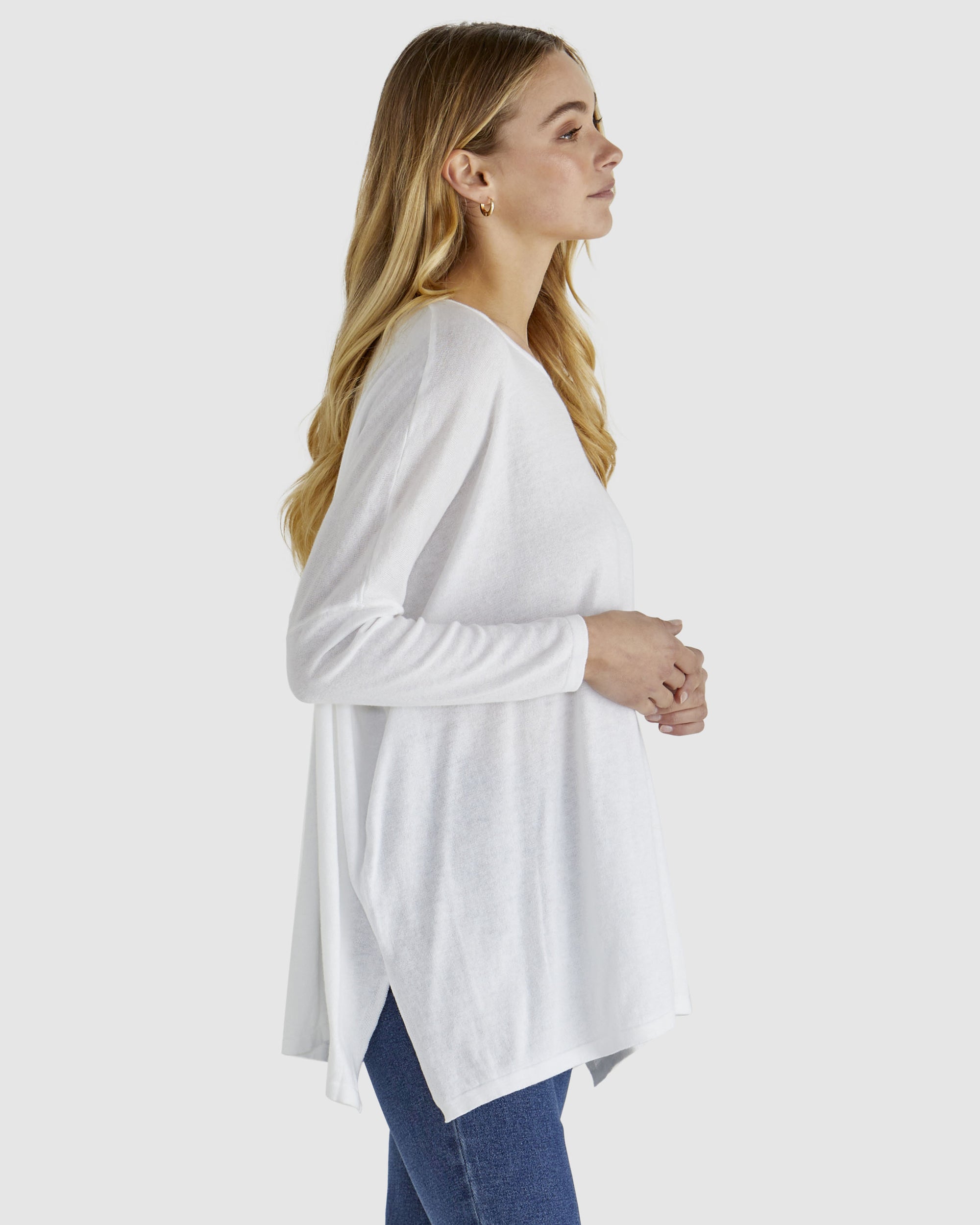 White Khaleesi Knit Top with long sleeves, side splits, relaxed fit and round neck by Betty Basics.