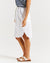 side view of Alina White denim skirt with pockets and side splits by Betty Basics.