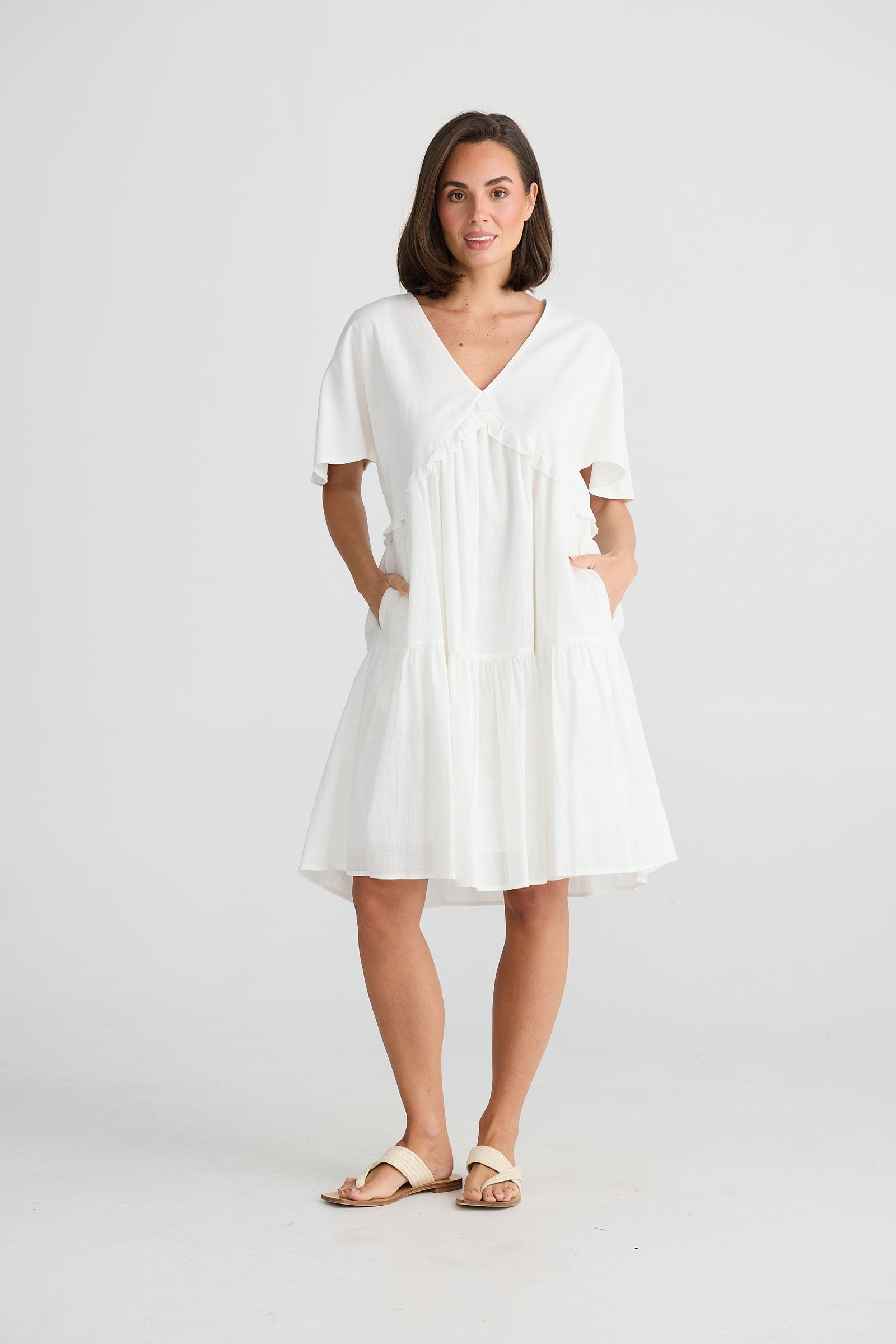 Model Wearing Lola Tiered Cotton Midi dress in White by Holiday. 