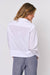 Back of relaxed fit straight hem white cotton long sleeve shirt by Naturals by O&J. 