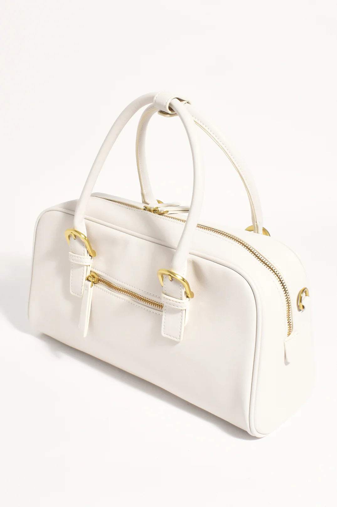 White with gold accents bowler style hand bag with crossbody strap by Adorne.