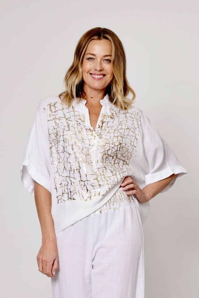 Model wearing La Strada&#39;s White Linen Foil Pattern Top in Gold Leaf. 