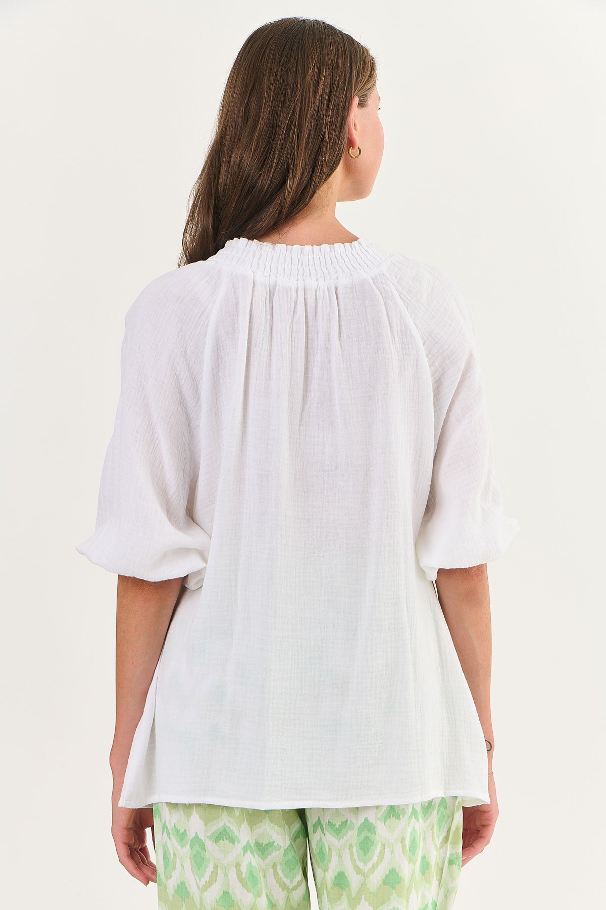 Back of Namastai crinkle cotton white top with gathered neck and tassels.