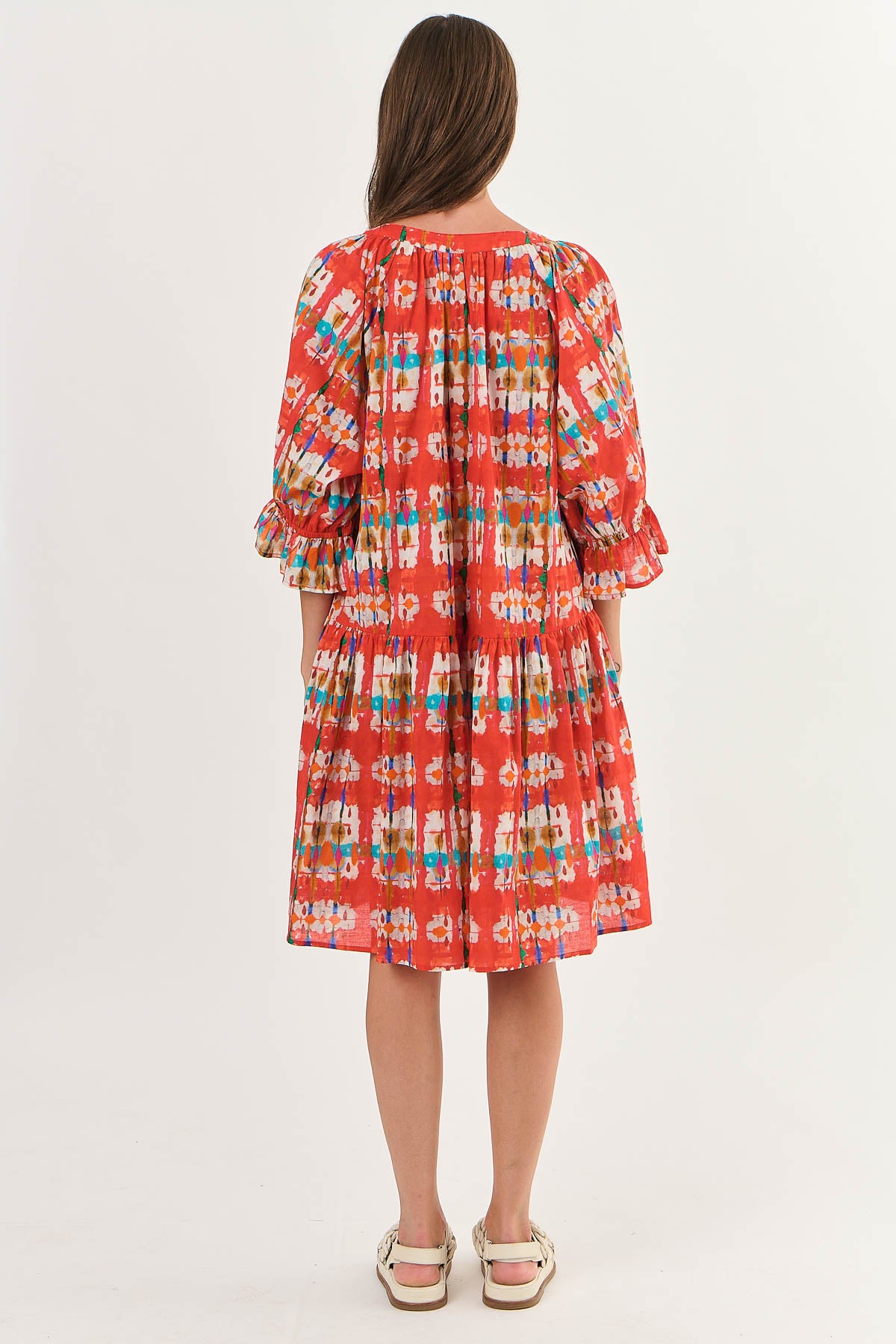 Back of Midi Dress with Elbow Length Sleeves with a ruffle, bright colours orange geometric print.