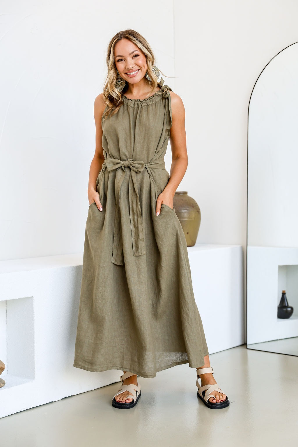 Model wearing Free Angel&#39;s Papavero Linen Sleeveless Maxi Dress in Slate a khaki green.