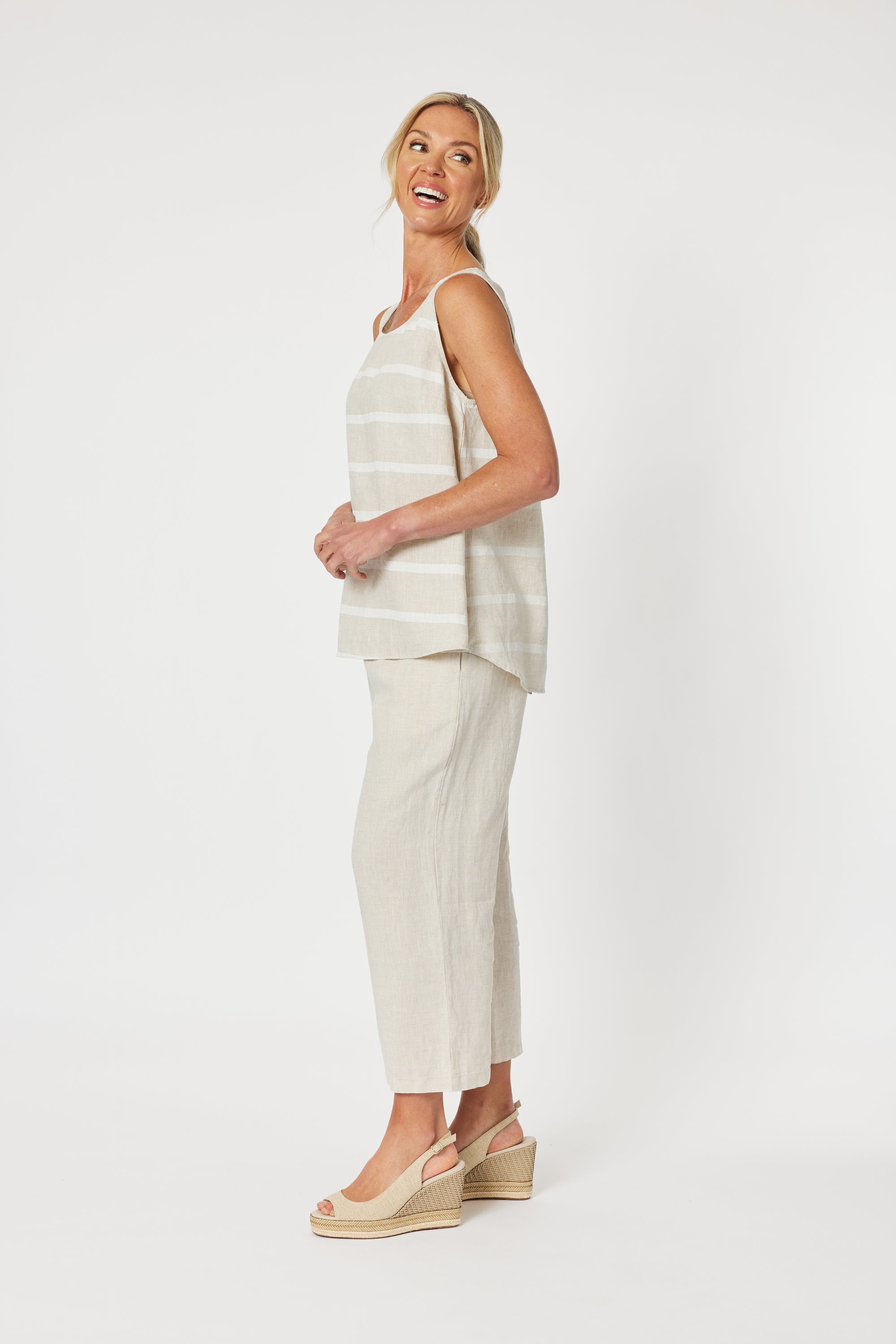 Patio Sleeveless Stripe Cami Tank Top in beige and White in a relaxed fit with high low hem curved at the back. 