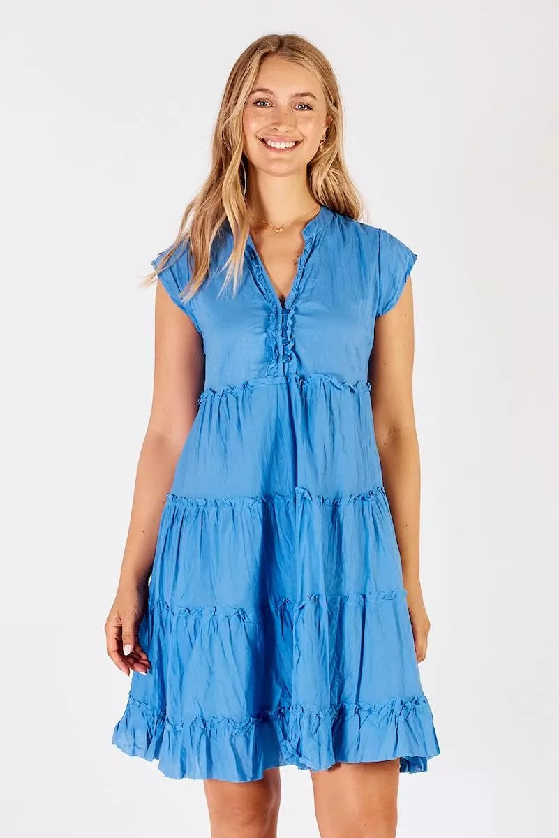 Model wearing the periwinkle blue v-neck-tiered midi dress with slight ruffles.