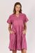 Ladies pink fuschia cotton midi dress with v-neck pink tuck gathering across chest and a tiered skirt.