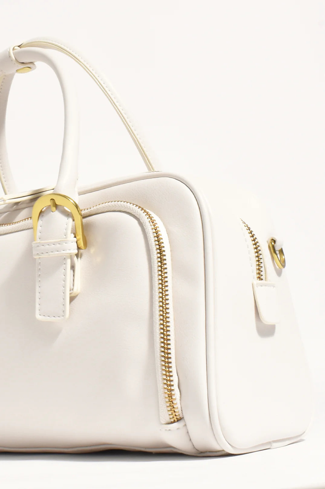 End view of the Ottilie cream white hand bag with gold accents and zip compartments by Adorne.