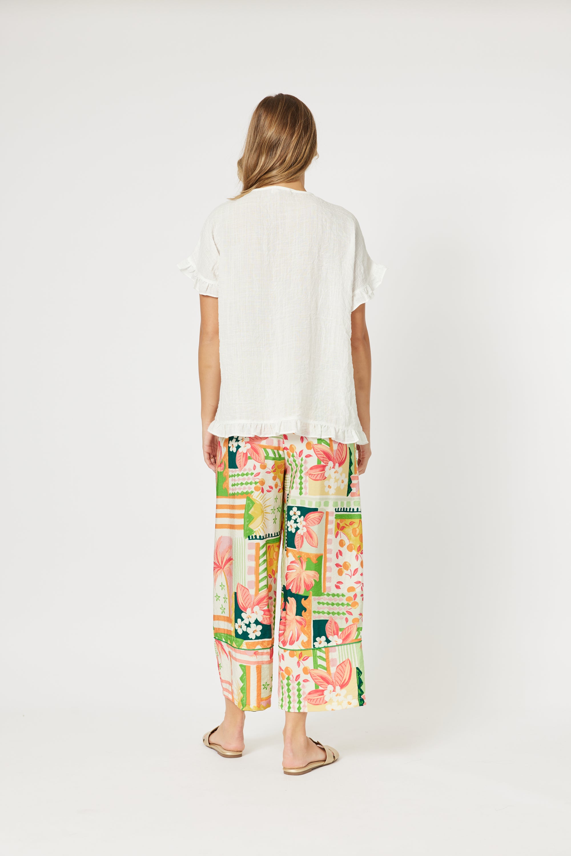 Back view of women's floral and geometric print Cancun trousers by Threadz. 