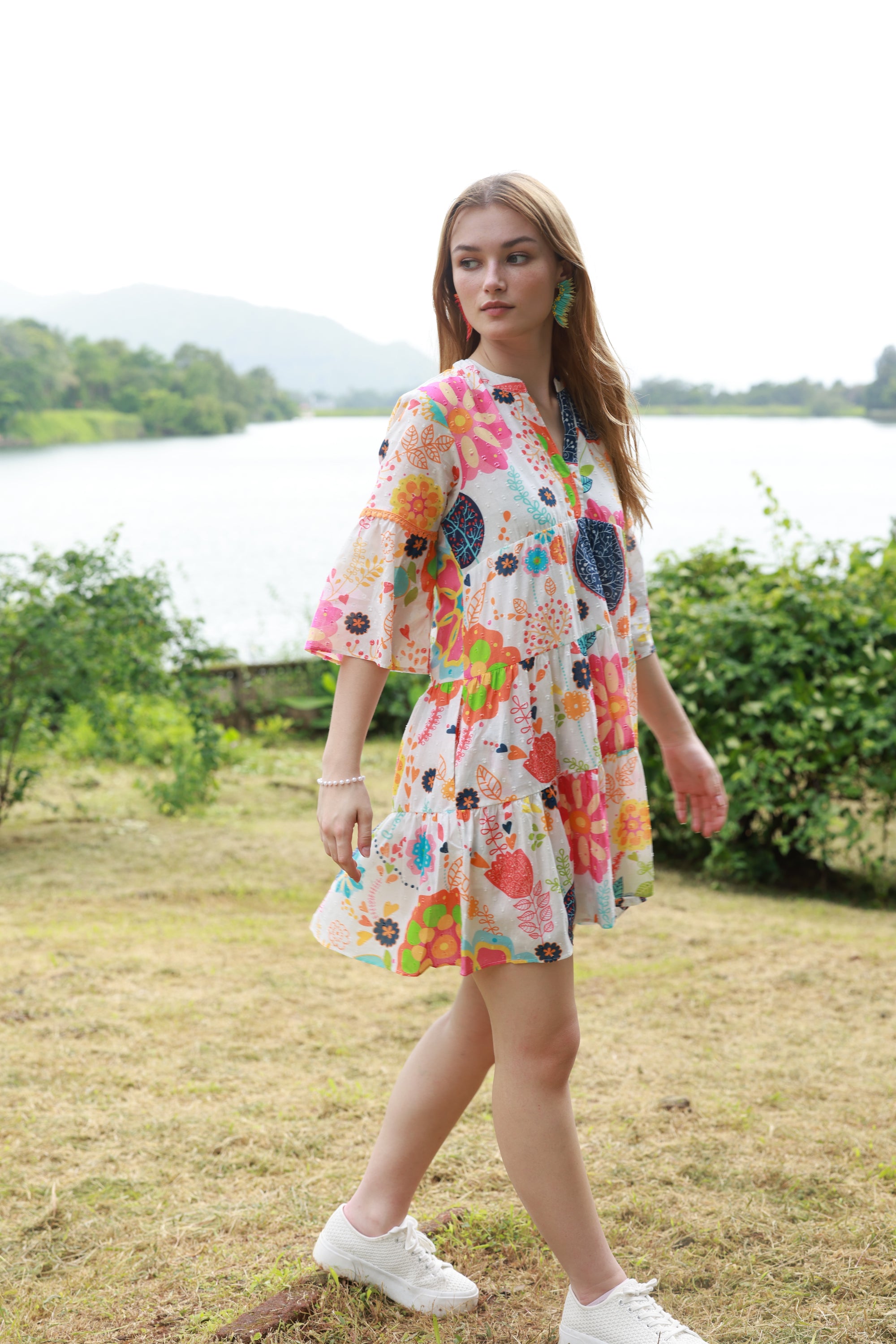 V-Neck dress with tiers white wendy dress with the print in blue, green pink, orange floral and leaf.