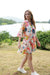 V-Neck dress with tiers white wendy dress with the print in blue, green pink, orange floral and leaf.